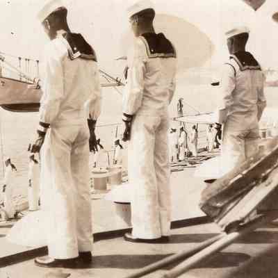 Sailors stand at deck's edge