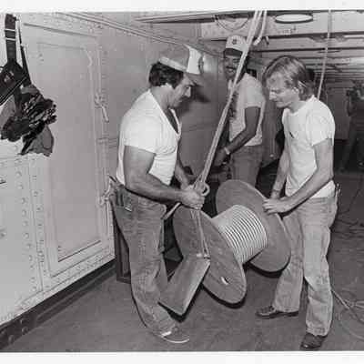 Volunteers work on rope spool