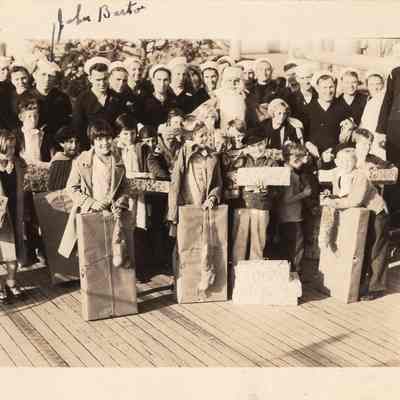 Children getting presents from crew
