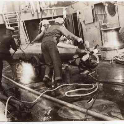 Men push torpedo