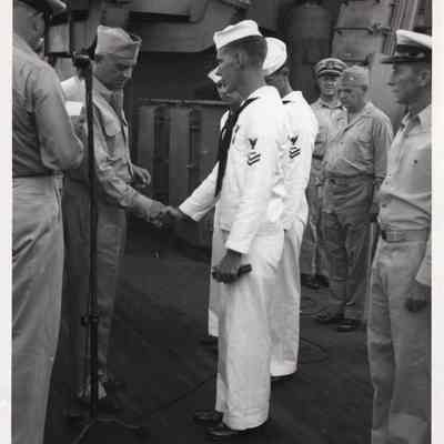 1948 Press Photo officer shakes sailor's hand