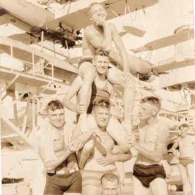 Sailors stack each other