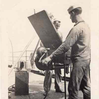 Sailors working on equipment
