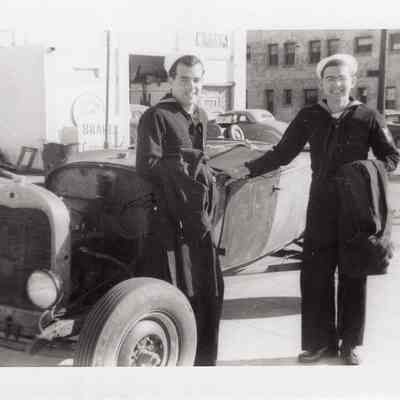 Sailors lean on car