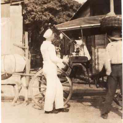 Sailor by horse-drawn carriage