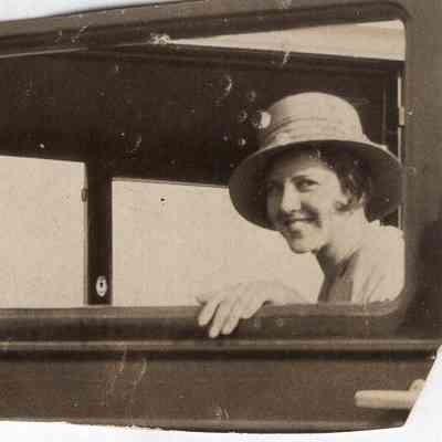 Woman smiles out car window