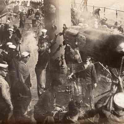 Sailors moving torpedo