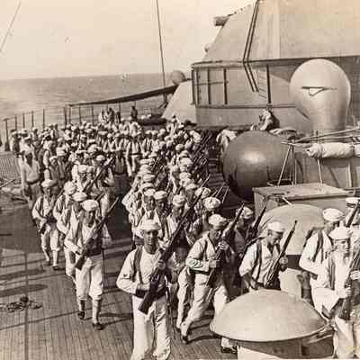 Men running drill on stern
