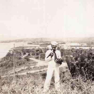 Sailor on hill over bay