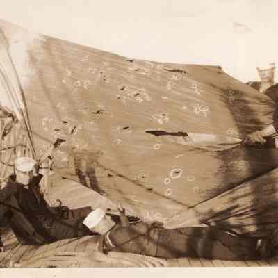 Sailors pointing out holes