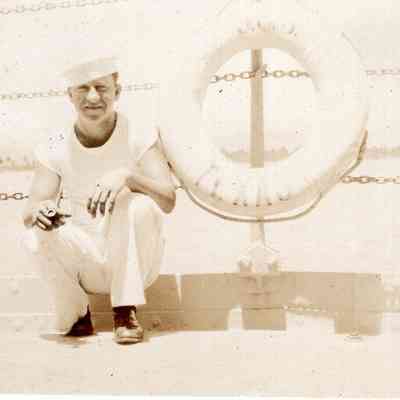Smoking sailor next to life preserver