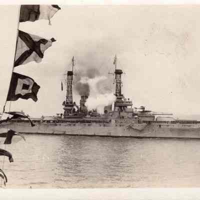 Men salute passing ship