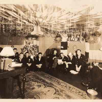 sailors in compartment decorated for Christmas