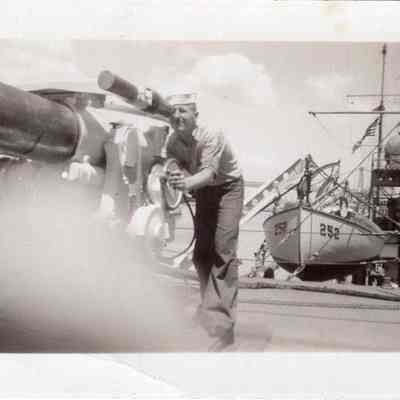 Sailor aims naval gun