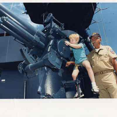 Child on 3"/50cal with man behind