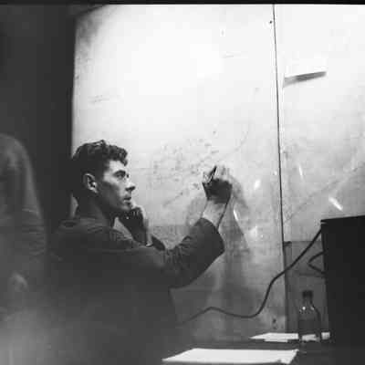 Soldier using communication gear and marking a wall map
