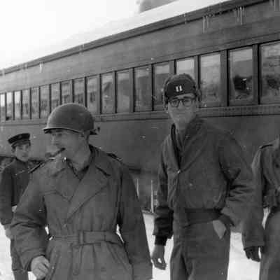 Officers pose in front of train