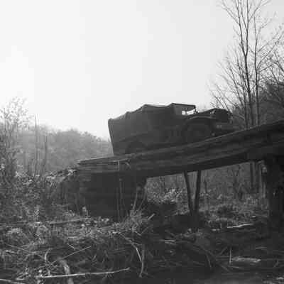 Truck broken through a wooden bridge
