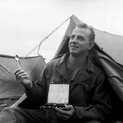 Soldier displaying boxed silverware set