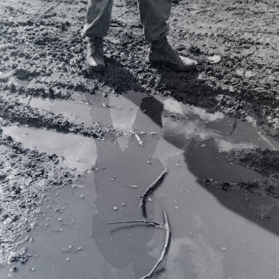 Soldier's reflection in a puddle of water
