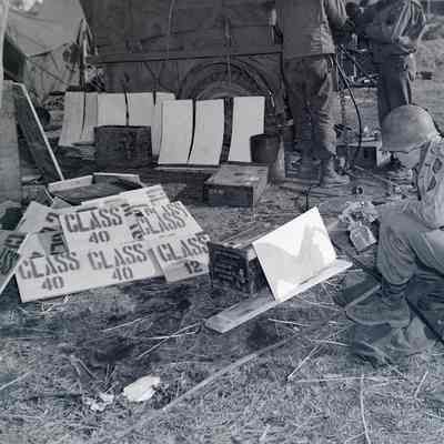 Soldier painting bridge signs