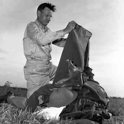 Soldier sorting through military clothing