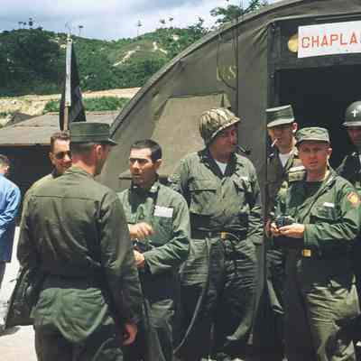 Chaplains talking in front of tent