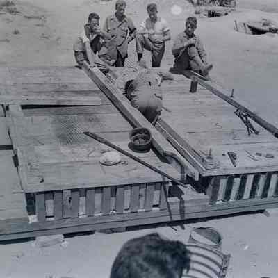 Soldiers assembling a prefabricated bridge