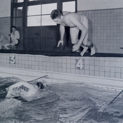 Soldiers swimming in an indoor pool
