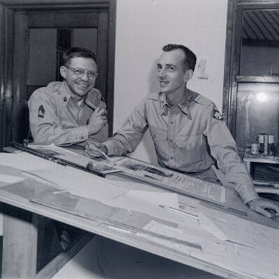 Two soldiers with a newspaper layout board
