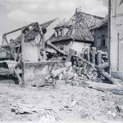 Soldier clearing debris with bulldozer