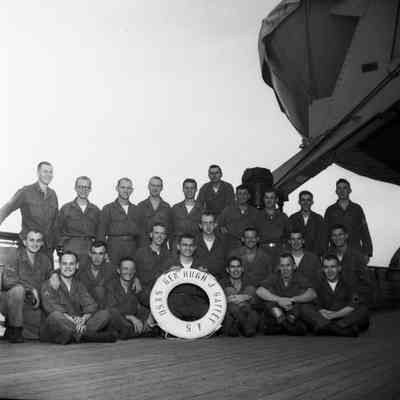Group photo of soldiers on ship's deck with life preserver "USNS Gen Hugh J Gaffey SF"