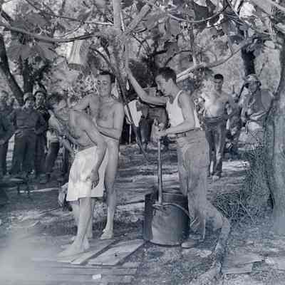 Soldiers using improvised field shower
