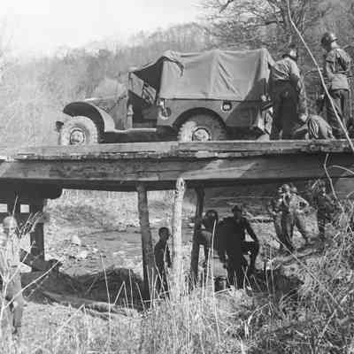 Soldiers securing a wooden bridge