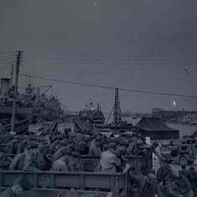 Soldiers unloading from transport trucks