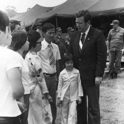 Govenor David Boren meeting a refugee family from Vietnam