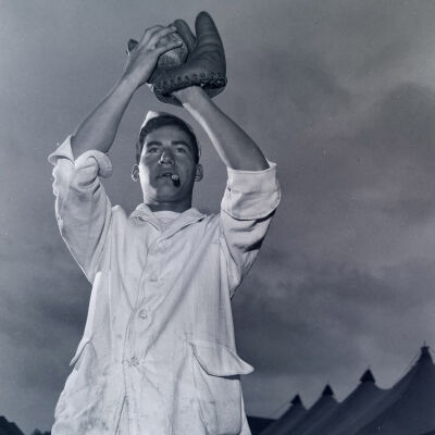 Cook posing with baseball glove and baseball