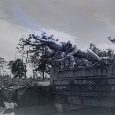 Two soldiers diving off a bridge