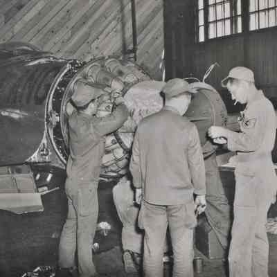 Maintenace crew works on F-80 engine
