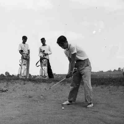 Soldier and two Japanese playing golf