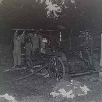 Soldiers pumping water for mobile laundry setup