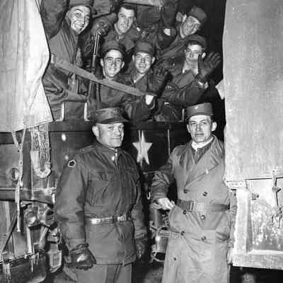 Soldiers waving from a truck