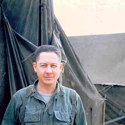 Solider standing in front of tents
