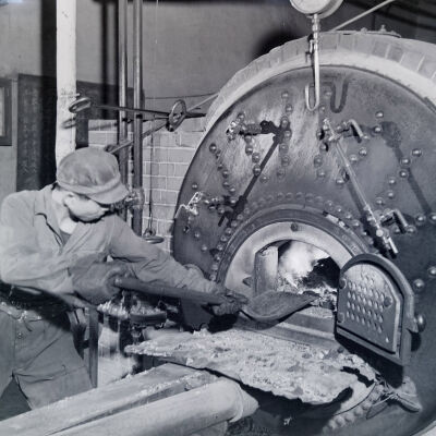 Japanese man stoking a boiler