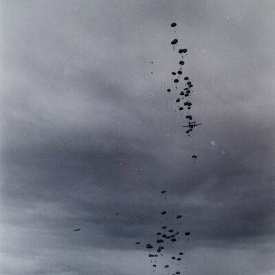 Troops dropping in parachutes