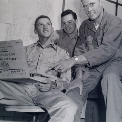 Soldiers looking at a Baseball Score Guide Box Score Book