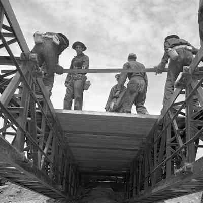 Soldiers constructing a bridge
