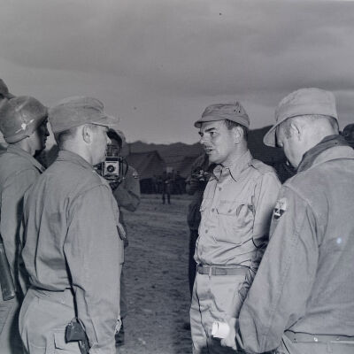 Officer addressing three soldiers