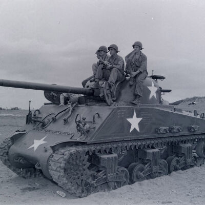 Soldiers riding on a tank