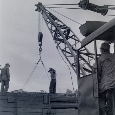 Soldiers using a crane to load cargo